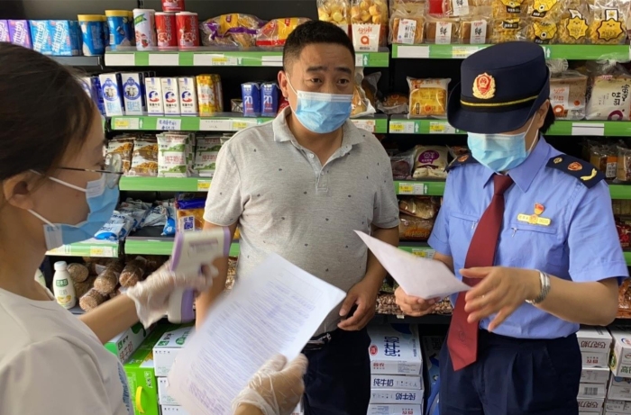朝阳区市场监管局执法人员在高考考点附近检查疫情防控和食品安全落实情况。