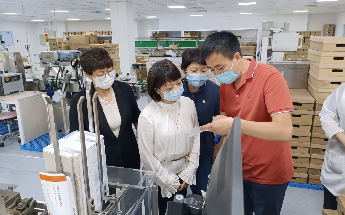 图为医疗器械注册处调研员在爱博诺德（北京）医疗科技股份有限公司开展现场调研。