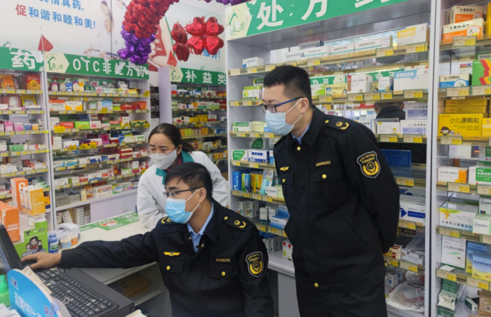 图为第六分局执法人员在一家药店检查疫情防控情况。