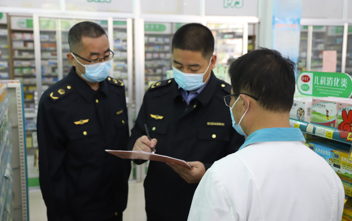 图为沂南县市场监管局执法人员在一家药店检查“四类药品”登记信息。
