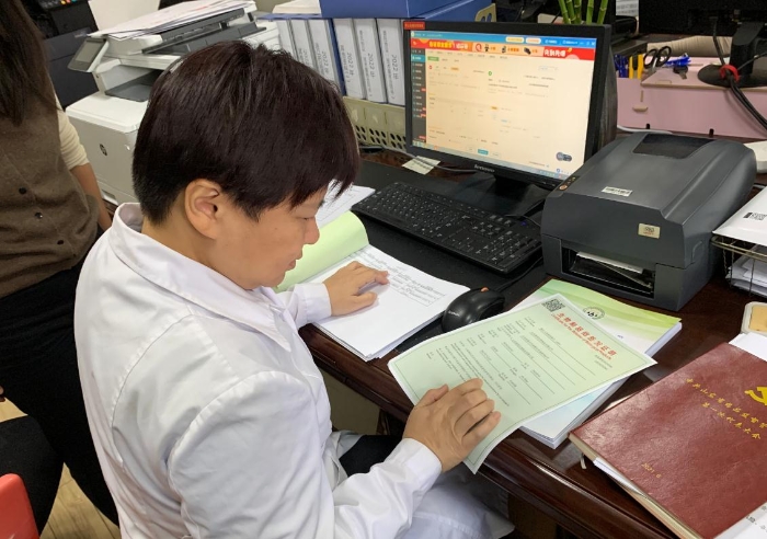 图为山东省食药检院药品业务科工作人员在签章前打印出预览件，核对检验品信息，确保电子证照内容准确无误。
