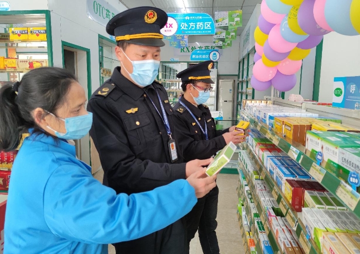 图为2月17日，该局执法人员在一家零售药店检查防疫药品质量。