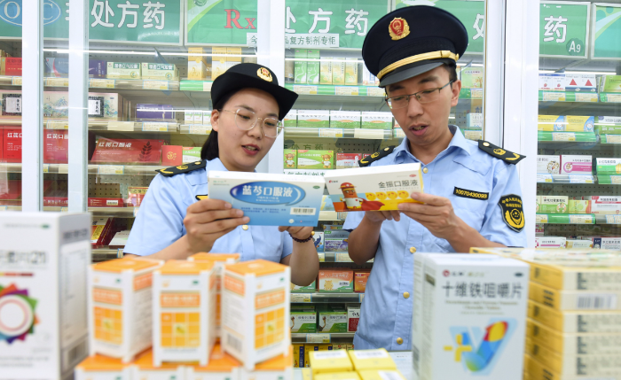 图为东海县市场监管局青湖分局执法人员在一家药店检查药品质量。