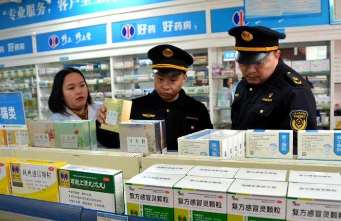 图为2月5日，监管人员在一家药店检查常备药销售情况。