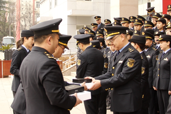 图为仪式现场，陕西省药监局领导向执法人员代表发放了执法装备（贺一辰摄）