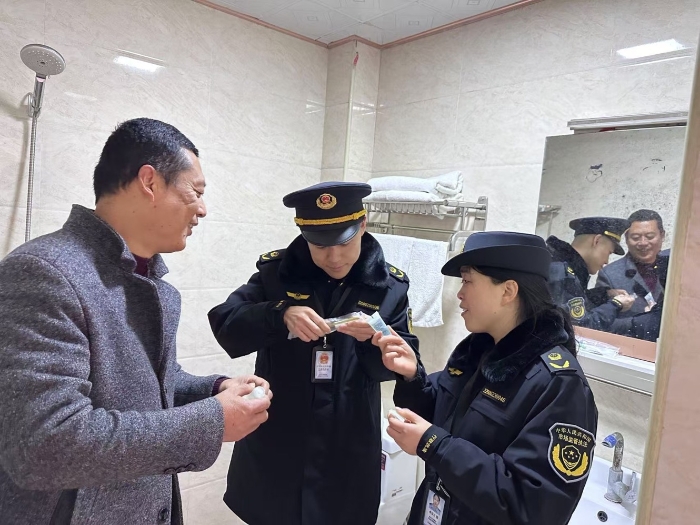 图为12月10日，该局马武镇市场监管所执法人员在一家宾馆检查化妆品的标签标识是否完整。